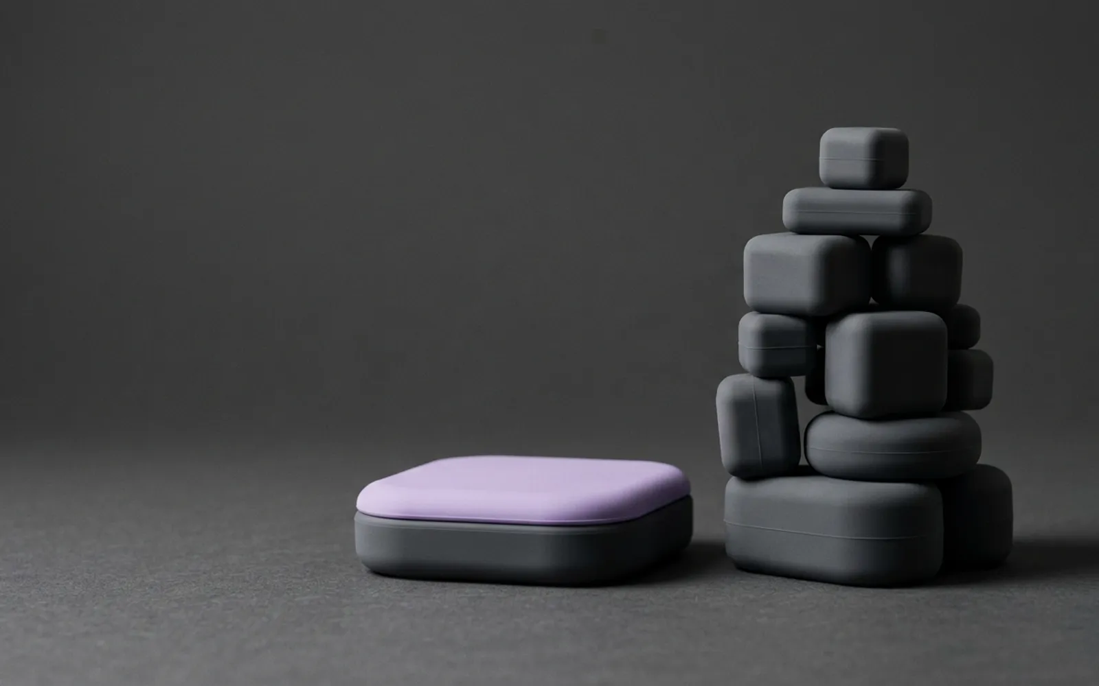 A single low soft slab next to a tall wobbly stack of blocks
